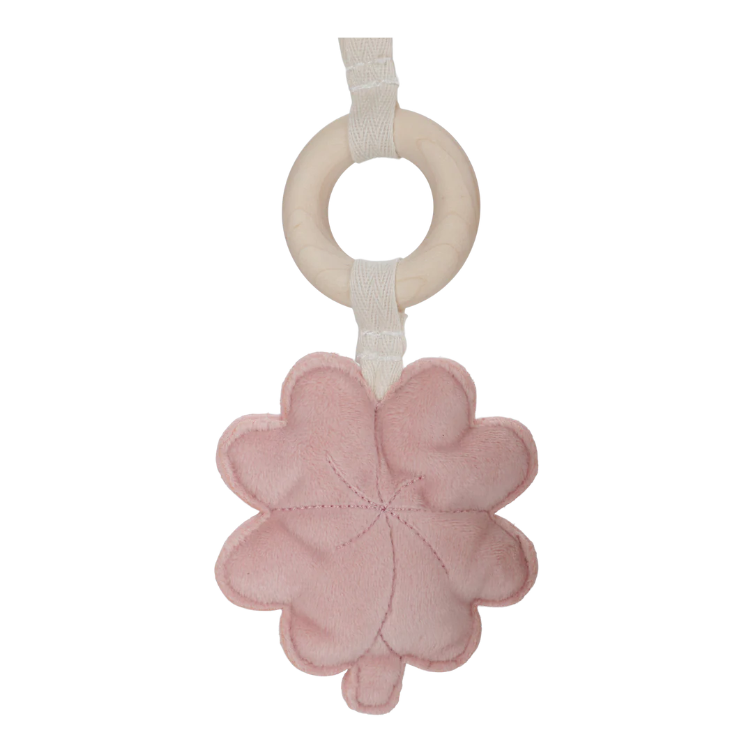 Pink flower-shaped baby rattle with a wooden ring on a white background