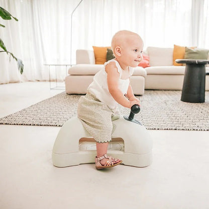 Baby playing with a toy in a living room