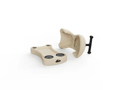 Beige plastic component with a black clasp on a white background