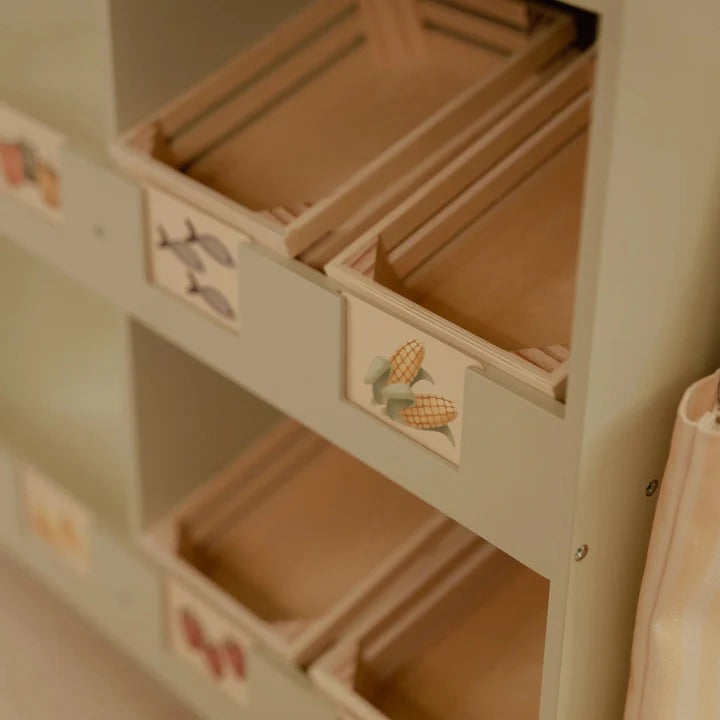 Children's cabinet with open drawers featuring illustrations on a light background