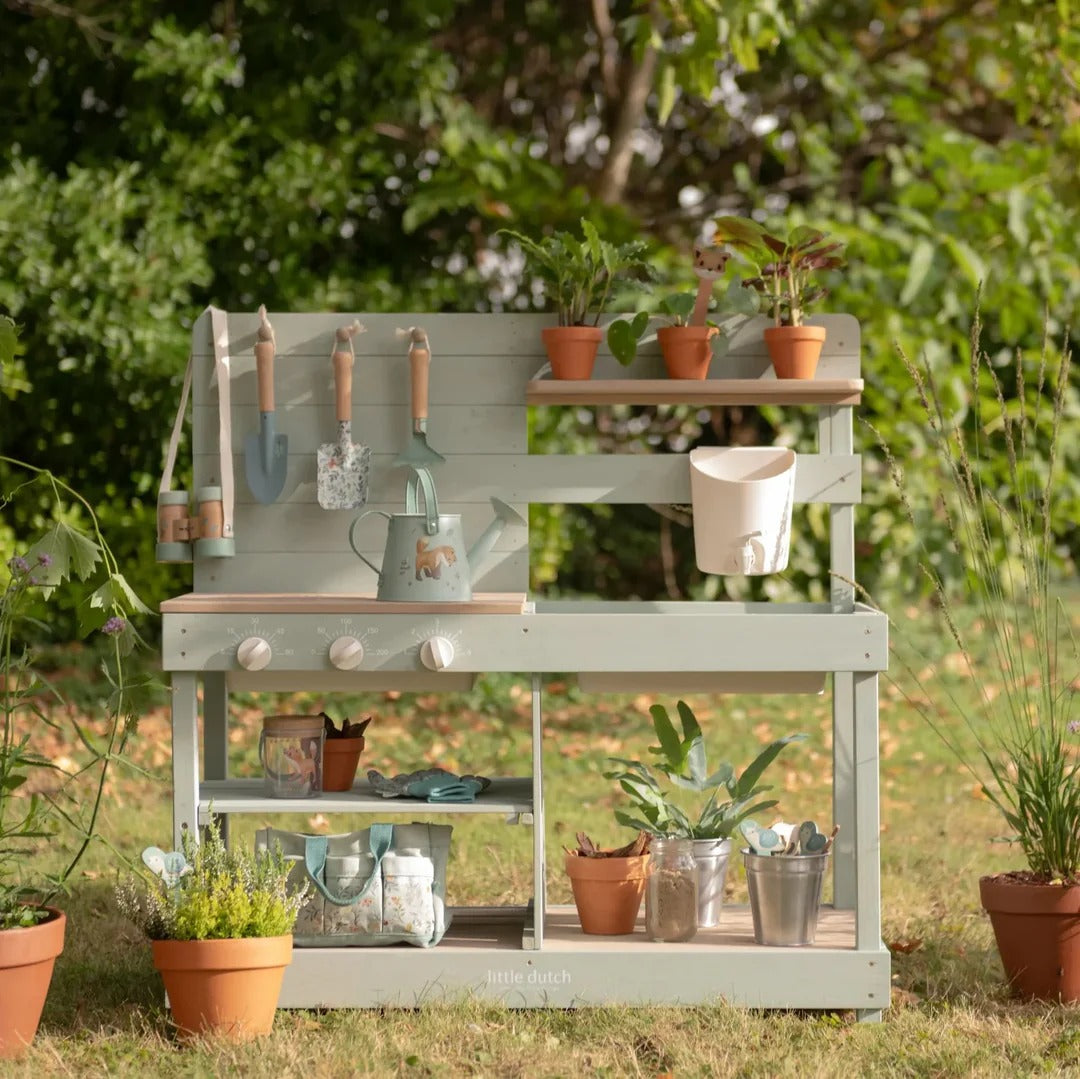 Gardening station with tools and plants in a garden setting