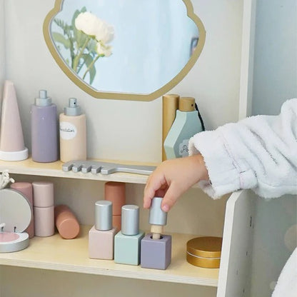 Pastel-colored nail polish bottles on a shelf with a hand reaching for one.