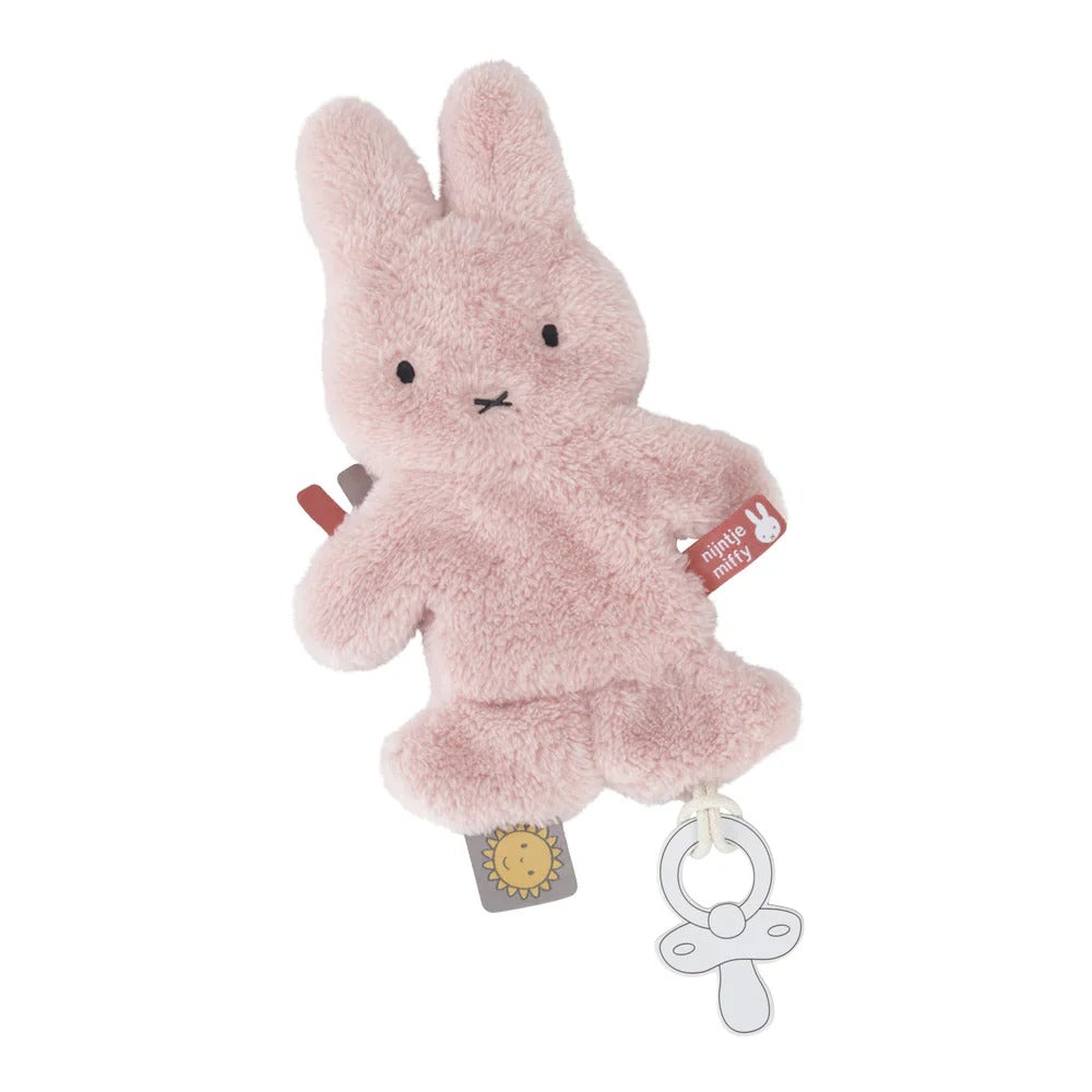 Pink plush bunny toy with a pacifier clip on a white background