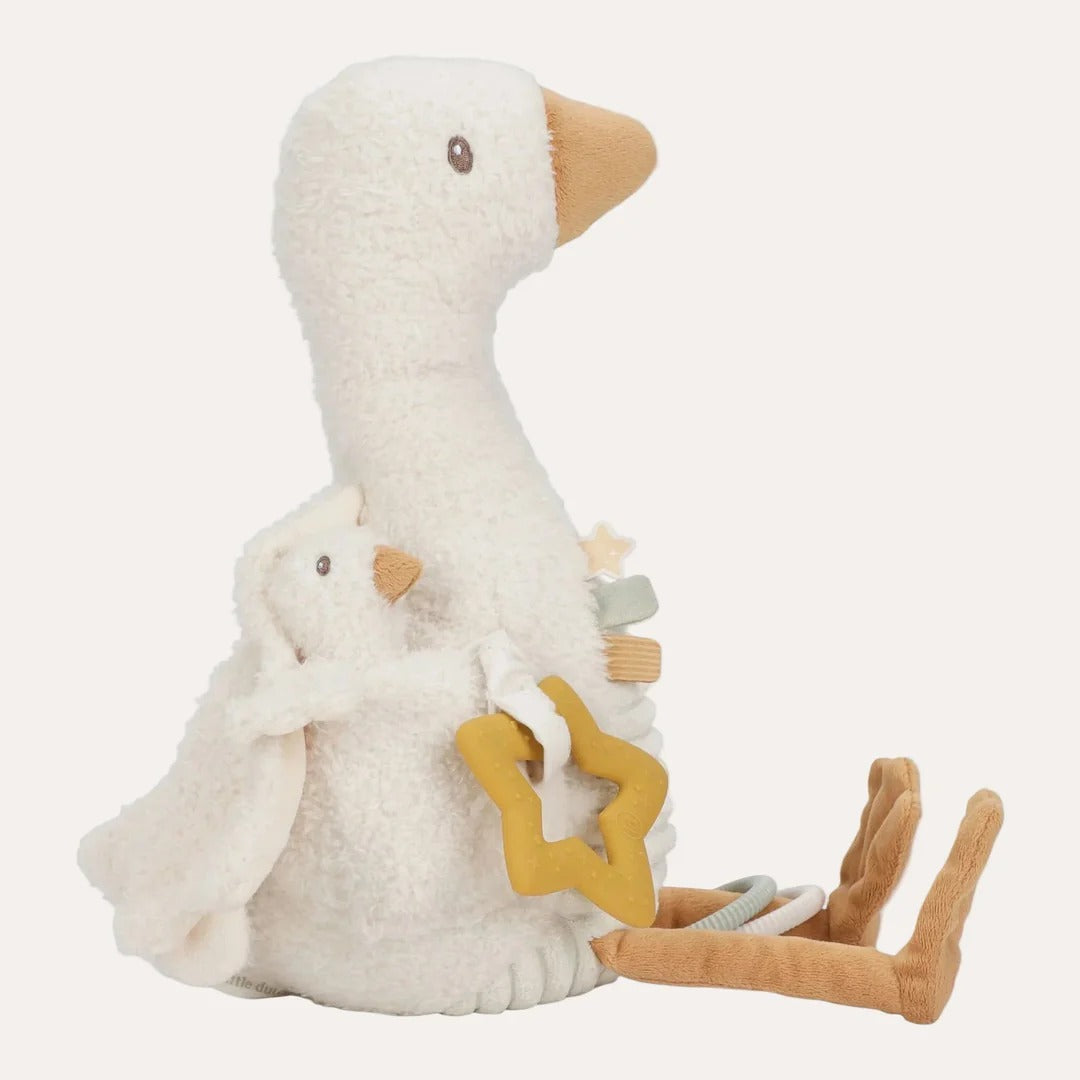 Plush toy goose with a smaller goose and a star-shaped object on a white background