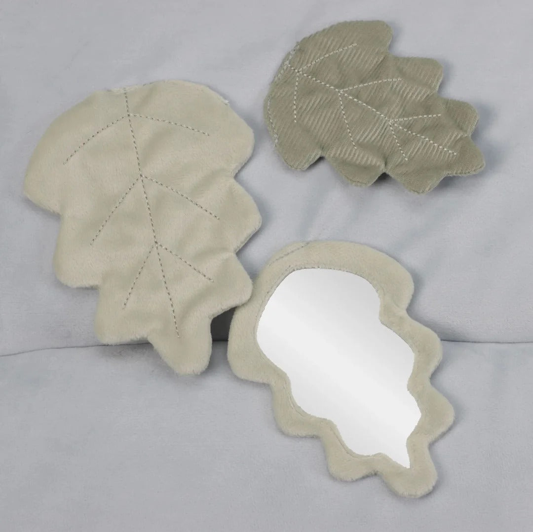 Three leaf-shaped mirrors on a gray background