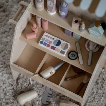 Toy makeup set with various items on a wooden stand