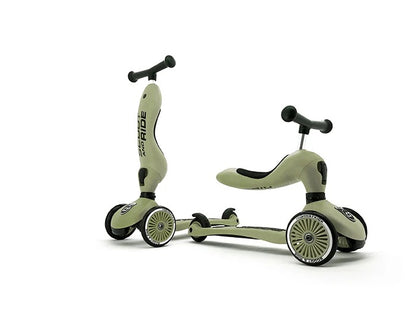 Two green children's scooters on a white background