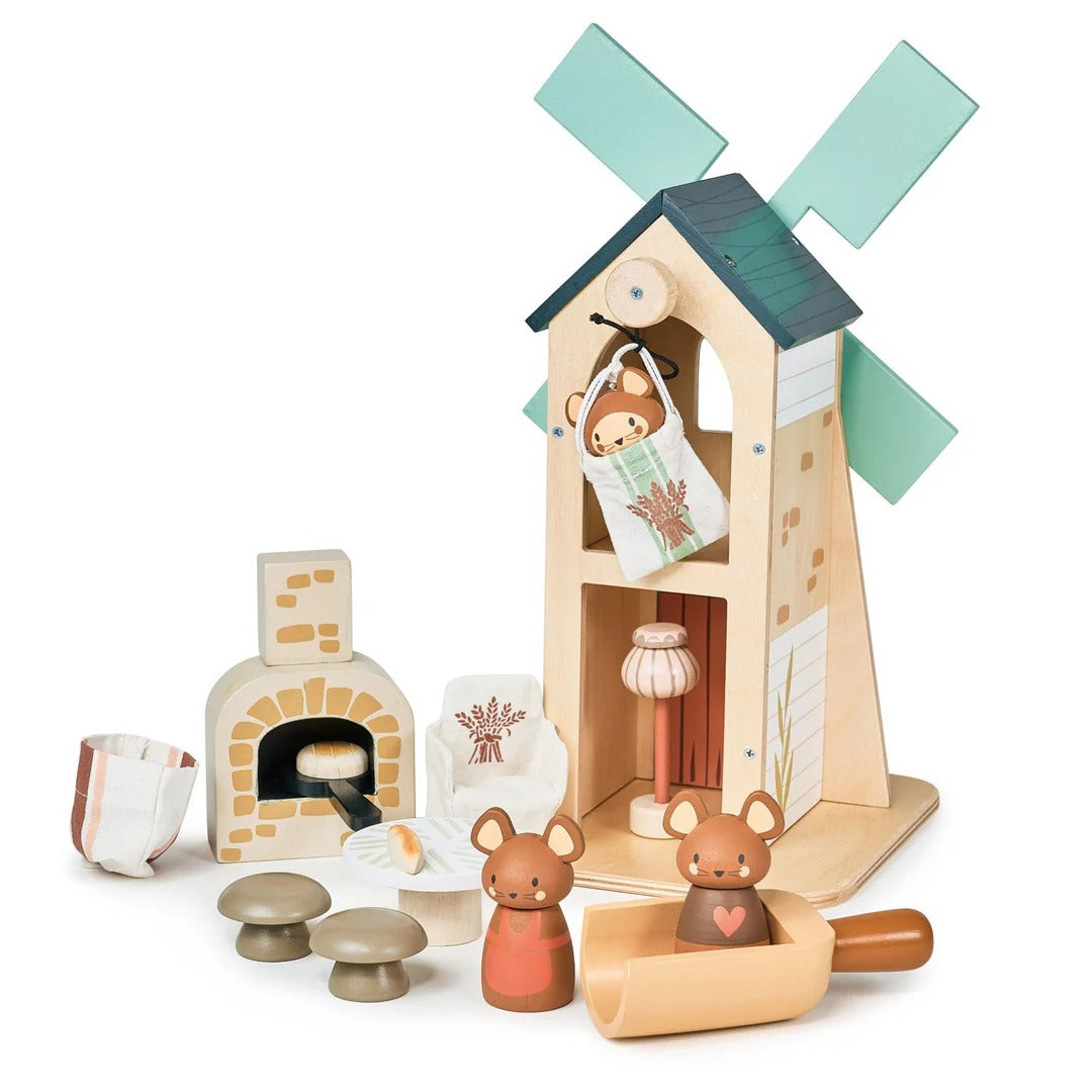 Wooden toy set with a windmill, fireplace, and small animals on a white background