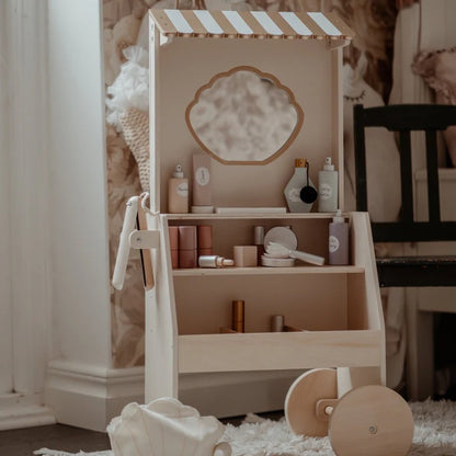 Wooden toy vanity with mirror and shelves in a room setting